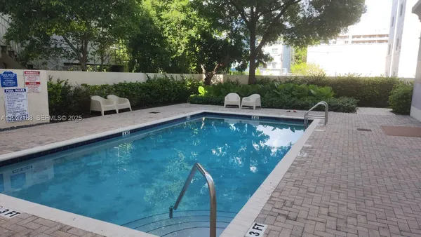 a view of swimming pool with a patio