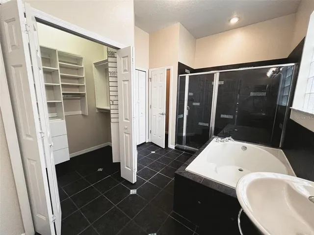 a bathroom with a tub and a shower