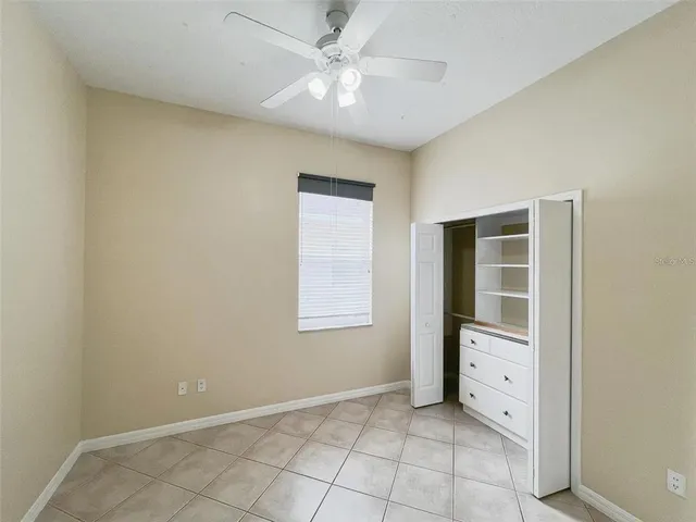 an empty room with windows and closet
