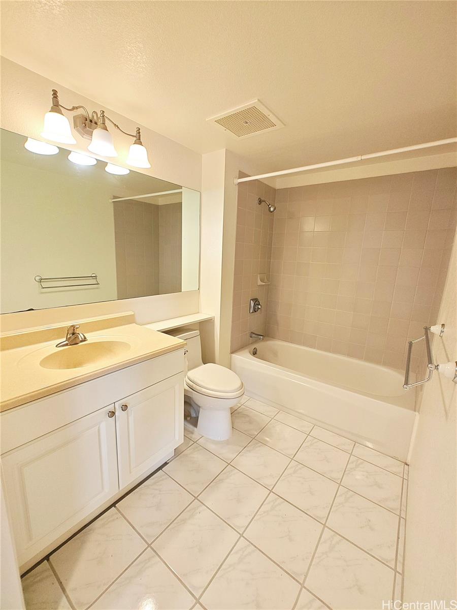 3054 Ala Poha Place, Unit 2005 Honolulu, HI 96818 - Photo 12 of 22 a bathroom with a double vanity sink mirror and toilet