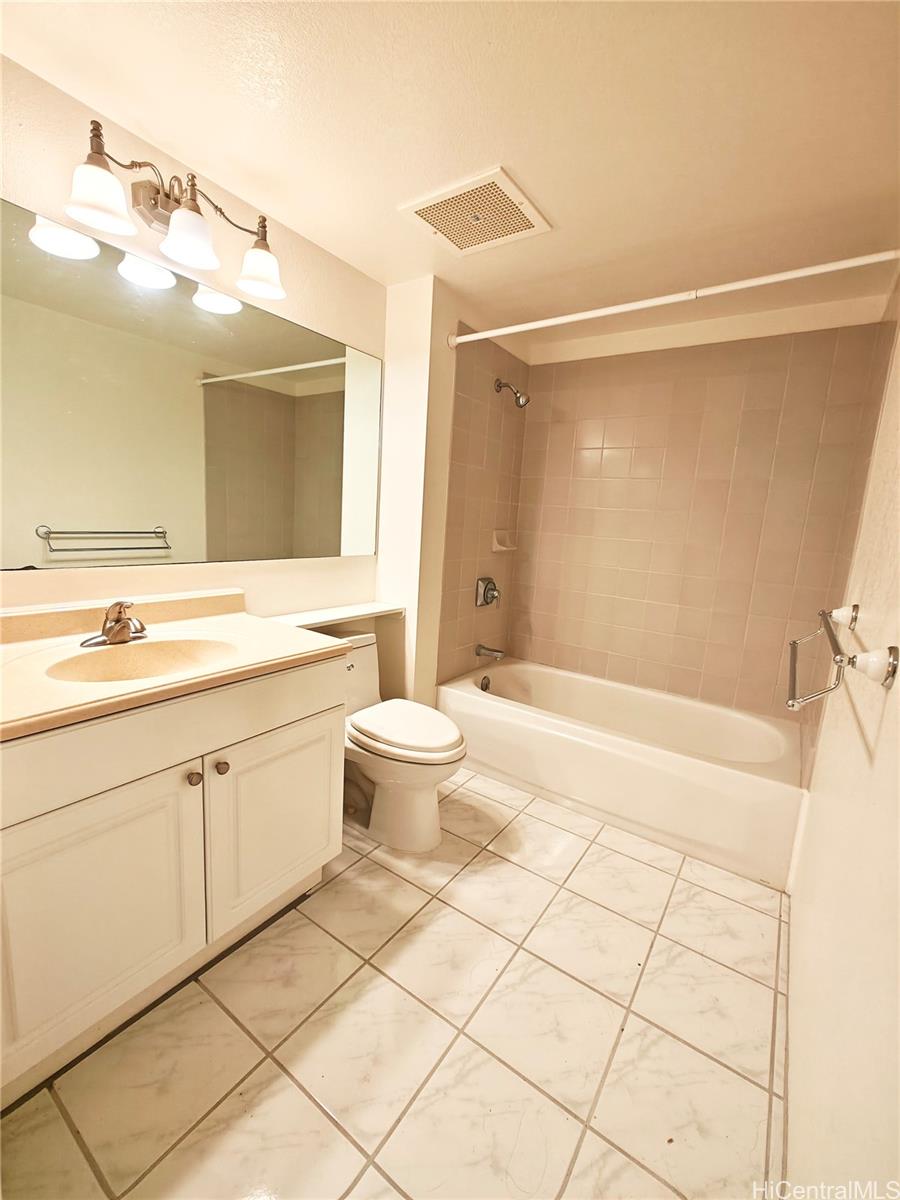 3054 Ala Poha Place, Unit 2005 Honolulu, HI 96818 - Photo 16 of 22 a bathroom with a sink a toilet and mirror