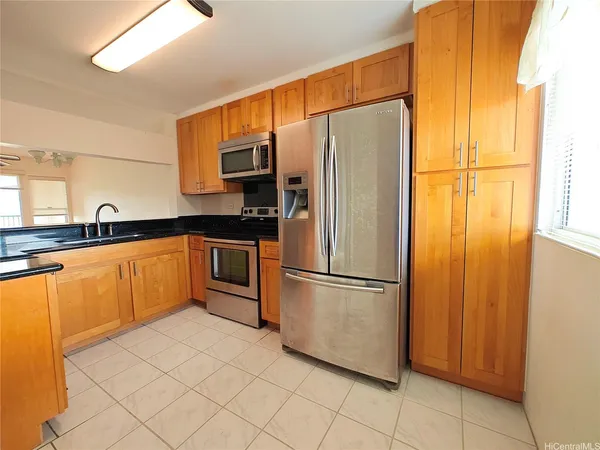a kitchen with stainless steel appliances a refrigerator and a sink