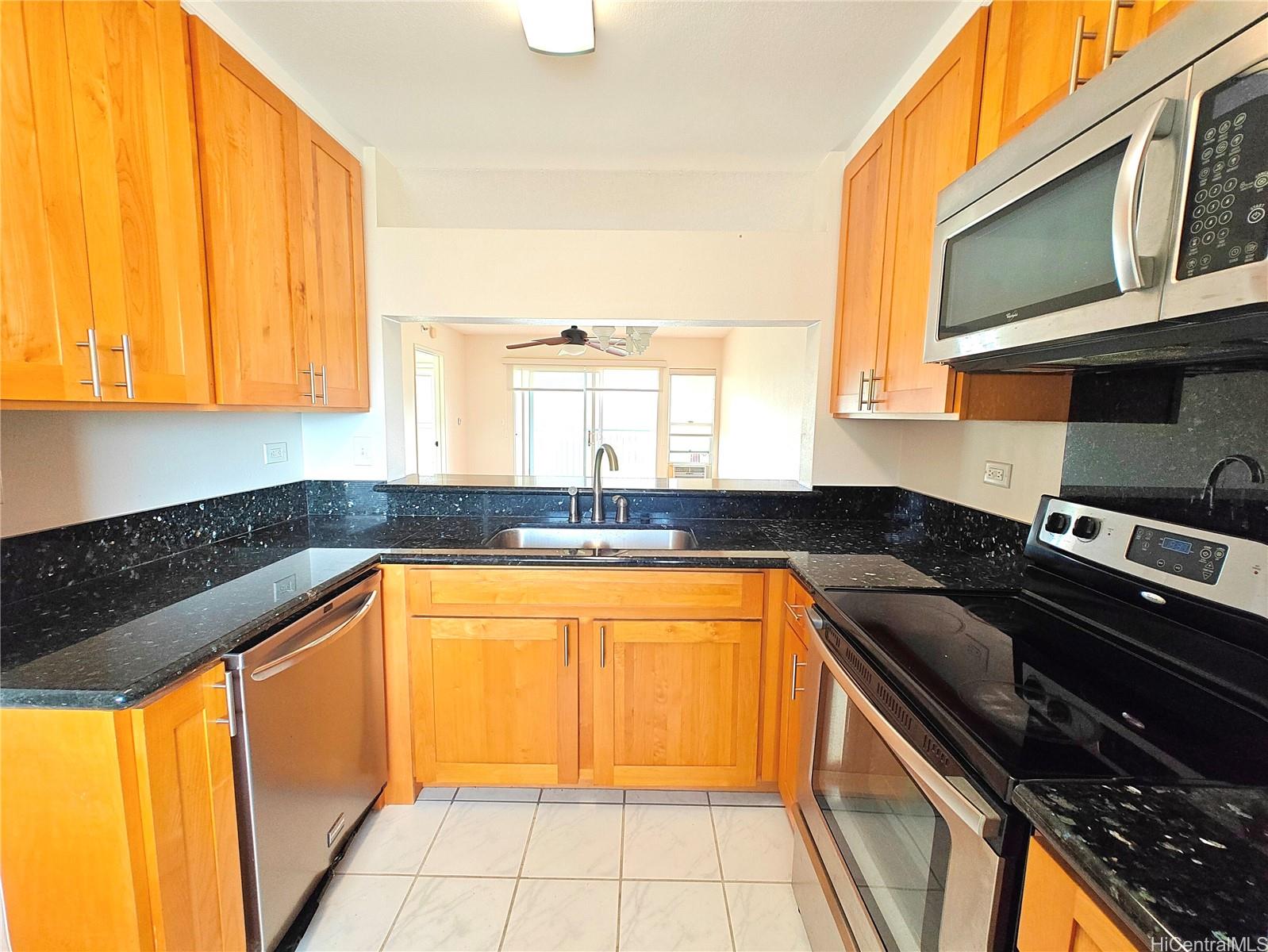 3054 Ala Poha Place, Unit 2005 Honolulu, HI 96818 - Photo 4 of 22 a kitchen with stainless steel appliances granite countertop a sink and a stove