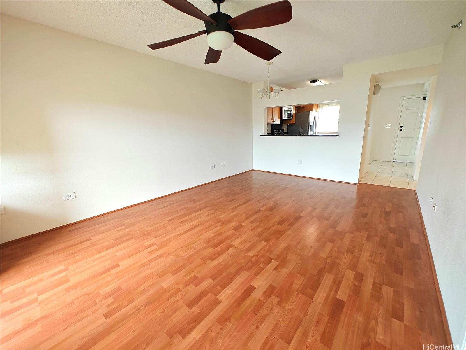 3054 Ala Poha Place, Unit 2005 Honolulu, HI 96818 - Photo 7 of 22 an empty room with wooden floor and windows