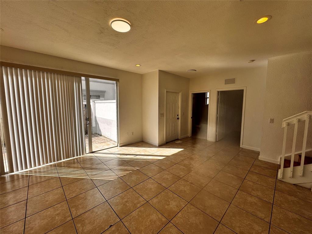 15746 Southwest 41st Street Miramar, FL 33027 - Photo 9 of 20 a view of an empty room with wooden floor