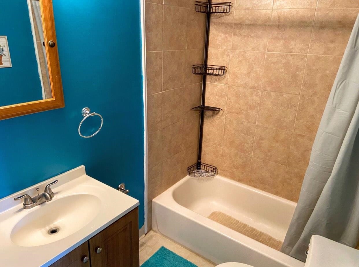 210 South Railroad Avenue Rio Grande, NJ 08242 - Photo 23 of 36 a bathroom with a sink a mirror and a bathtub