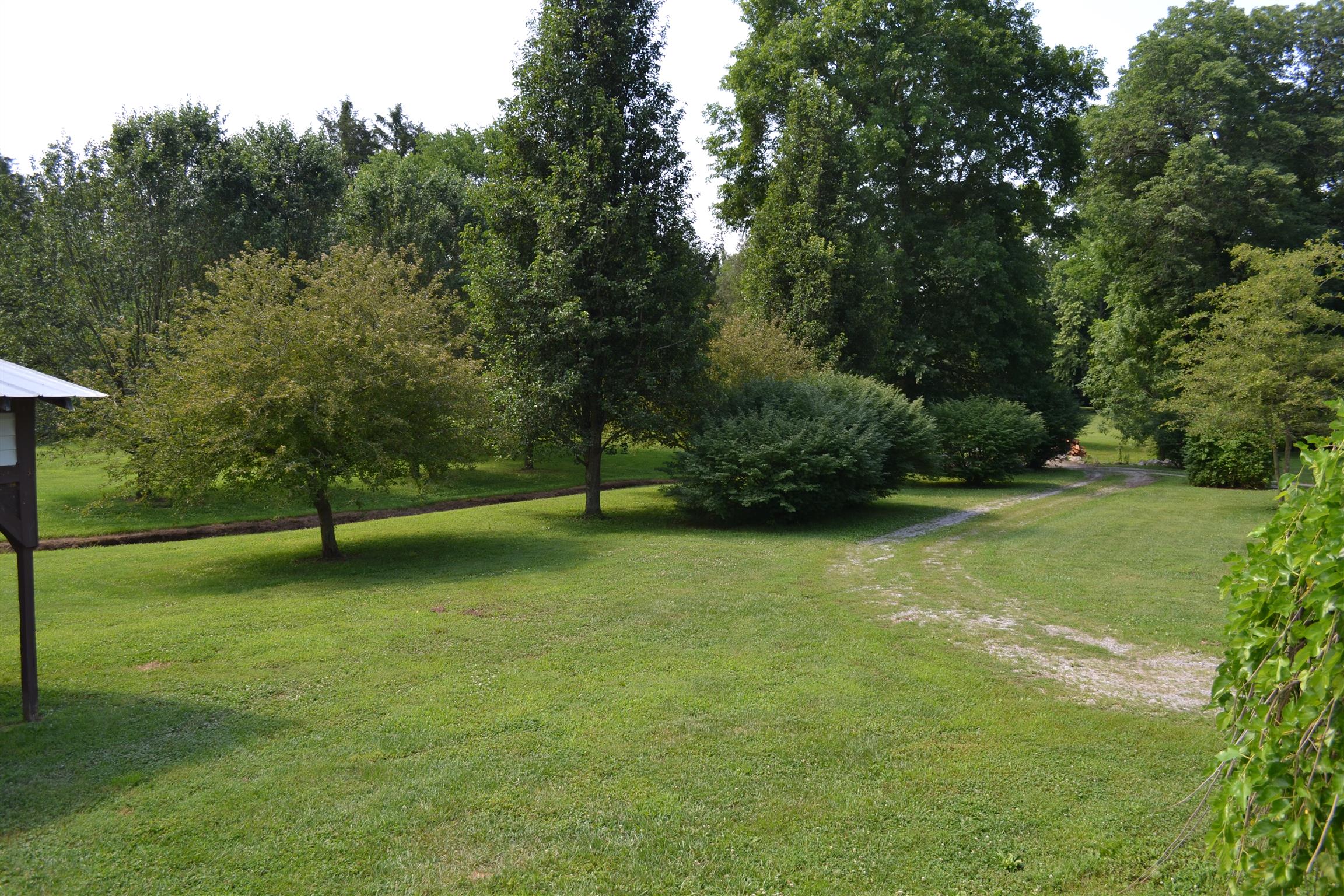 120 Rankin Road Hartsville, TN 37074 - Photo 11 of 20 GRAVEL DRIVEWAY WITH MATURE TREES AND A 3 BED 2 BATH MANUFACTURED HOME ON PERMANENT FOUNDATION ON 5 BEAUTIFUL ACRES