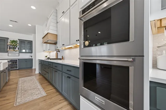 a kitchen with stainless steel appliances kitchen island granite countertop a stove a sink and a microwave