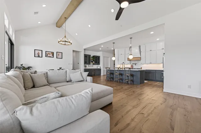 a living room with furniture and kitchen view