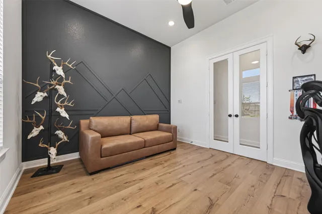 a living room with furniture and a wooden floor