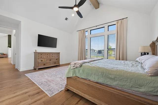 a bedroom with a bed and a flat screen television