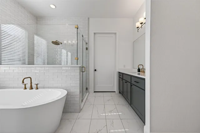 a spacious bathroom with a double vanity sink a mirror and a bathtub