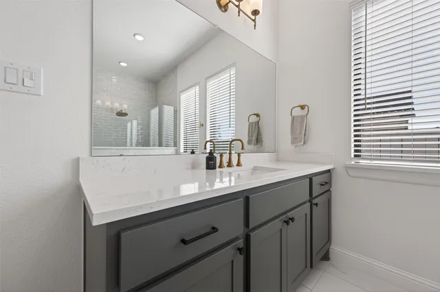 a bathroom with a sink double vanity and a mirror