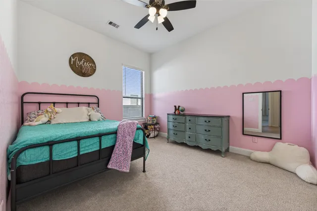 a bed room with a bed and a chair