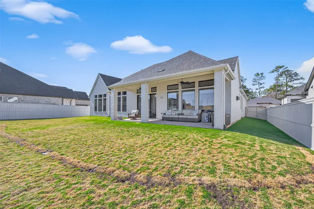 a view of a fountain in front of a house with a big yard