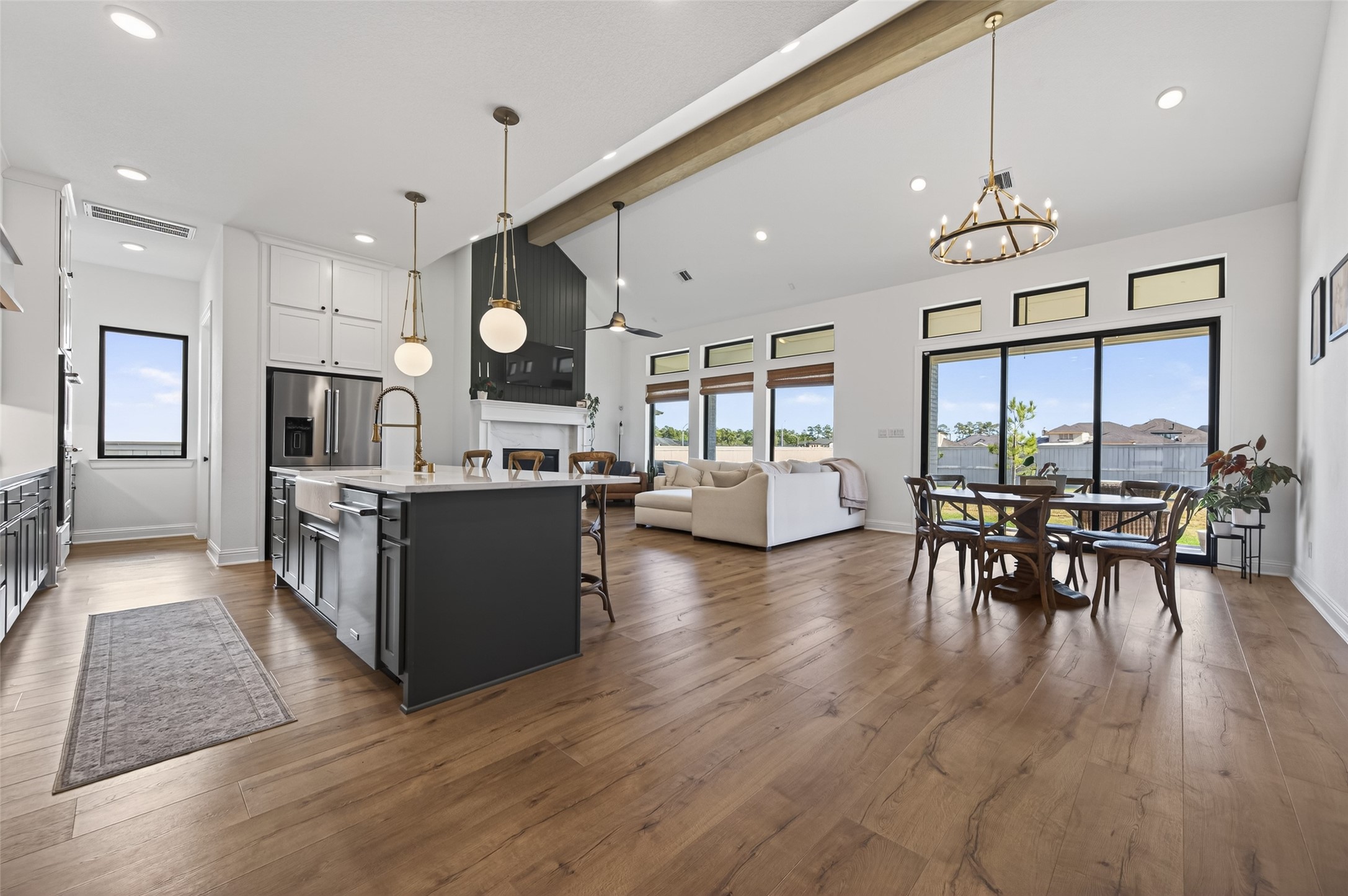 175 Shoveler Duck Way Magnolia, TX 77354 - Photo 6 of 47 a kitchen with stainless steel appliances granite countertop a stove top oven a refrigerator a dining table and chairs with wooden floor