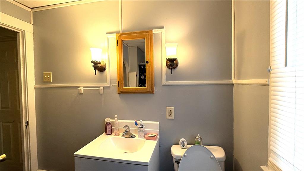 304 Spruce Avenue Sharon, PA 16146 - Photo 9 of 12 a bathroom with a sink mirror and vanity