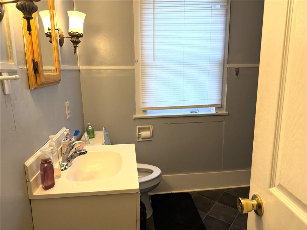 304 Spruce Avenue Sharon, PA 16146 - Photo 10 of 12 a bathroom with a sink and a mirror
