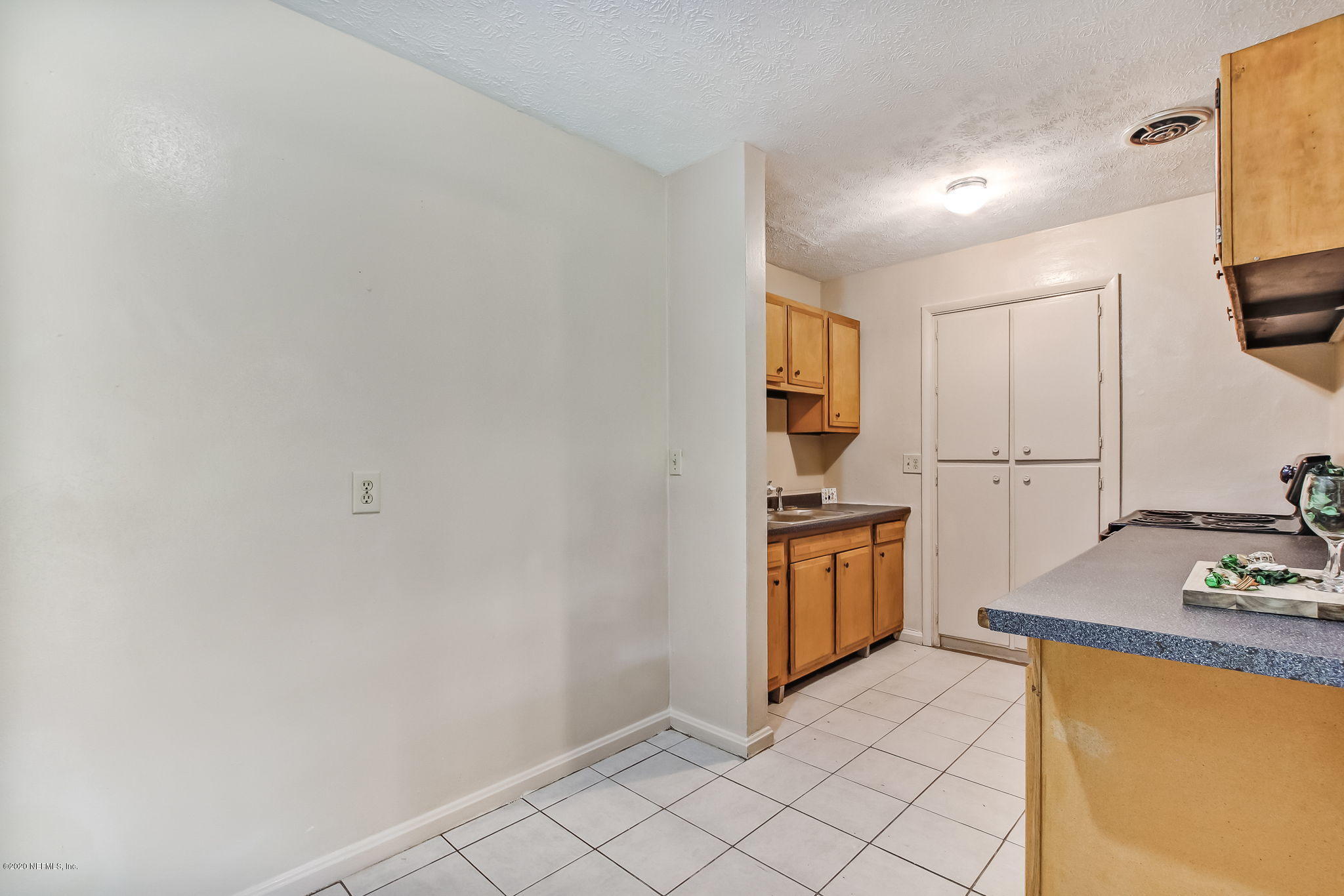6815 King Arthur Road Jacksonville, FL 32211 - Photo 11 of 32 a kitchen with stainless steel appliances granite countertop a refrigerator and a stove top oven