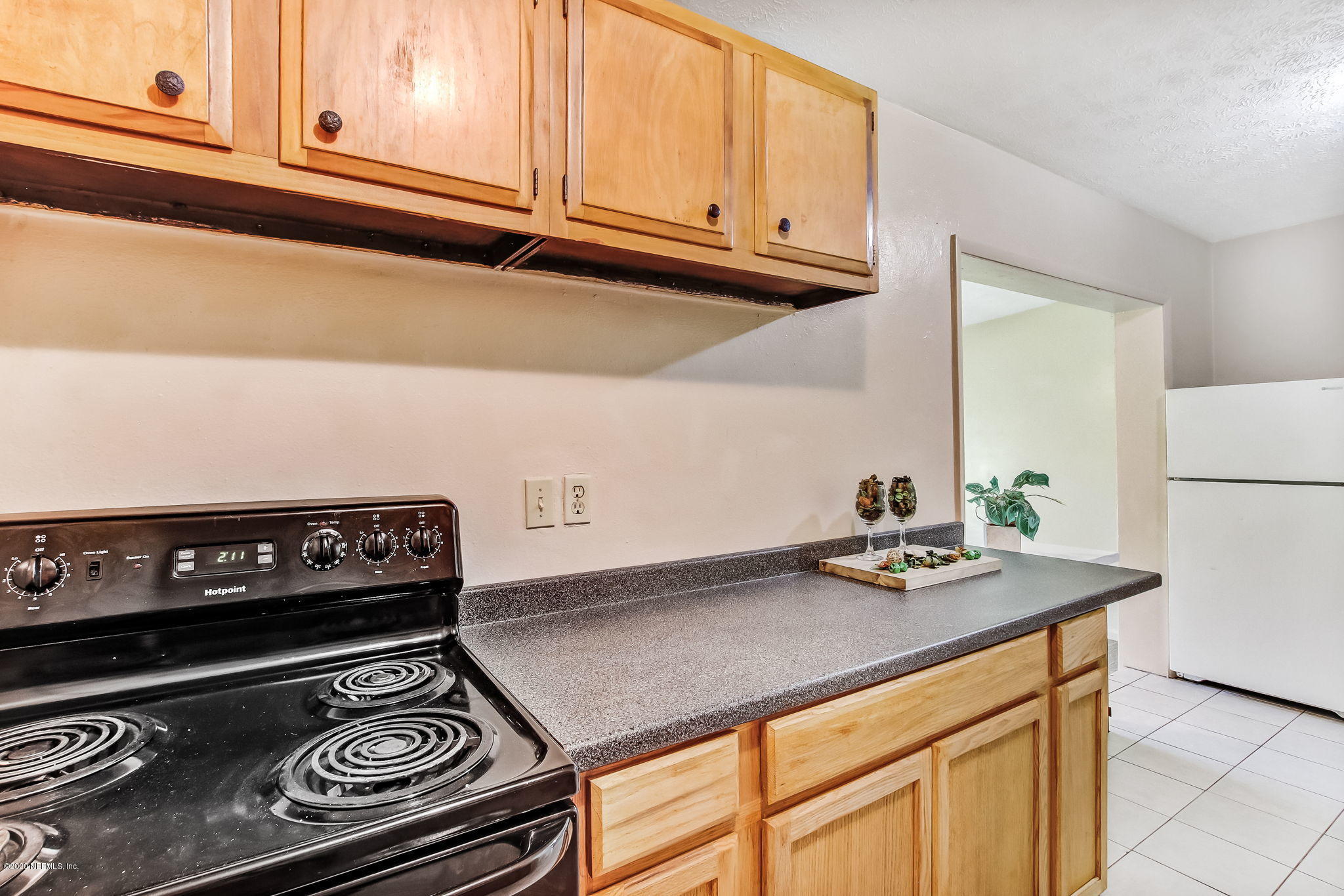 6815 King Arthur Road Jacksonville, FL 32211 - Photo 13 of 32 a kitchen with a stove and a refrigerator