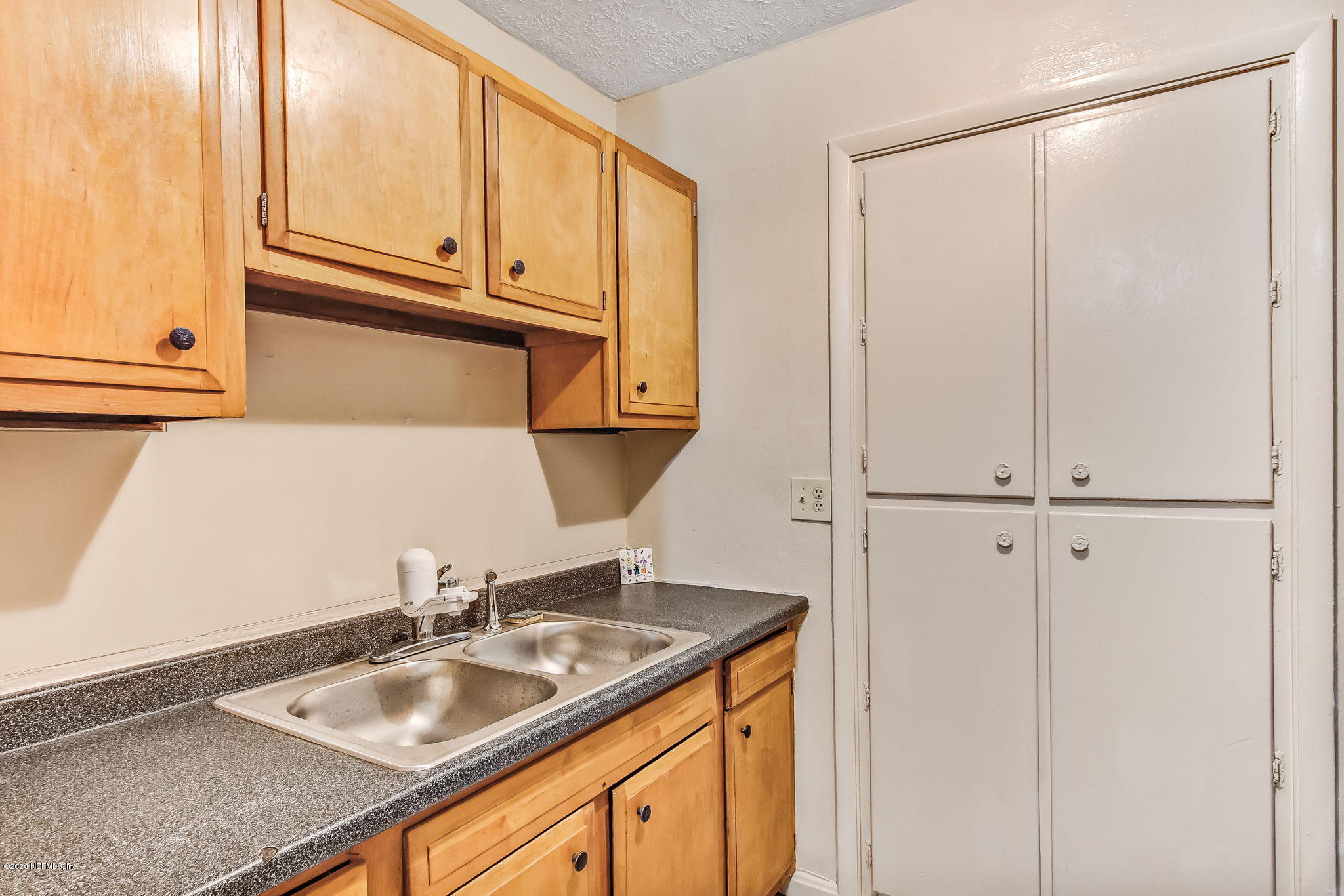 6815 King Arthur Road Jacksonville, FL 32211 - Photo 14 of 32 a bathroom with a sink and a mirror