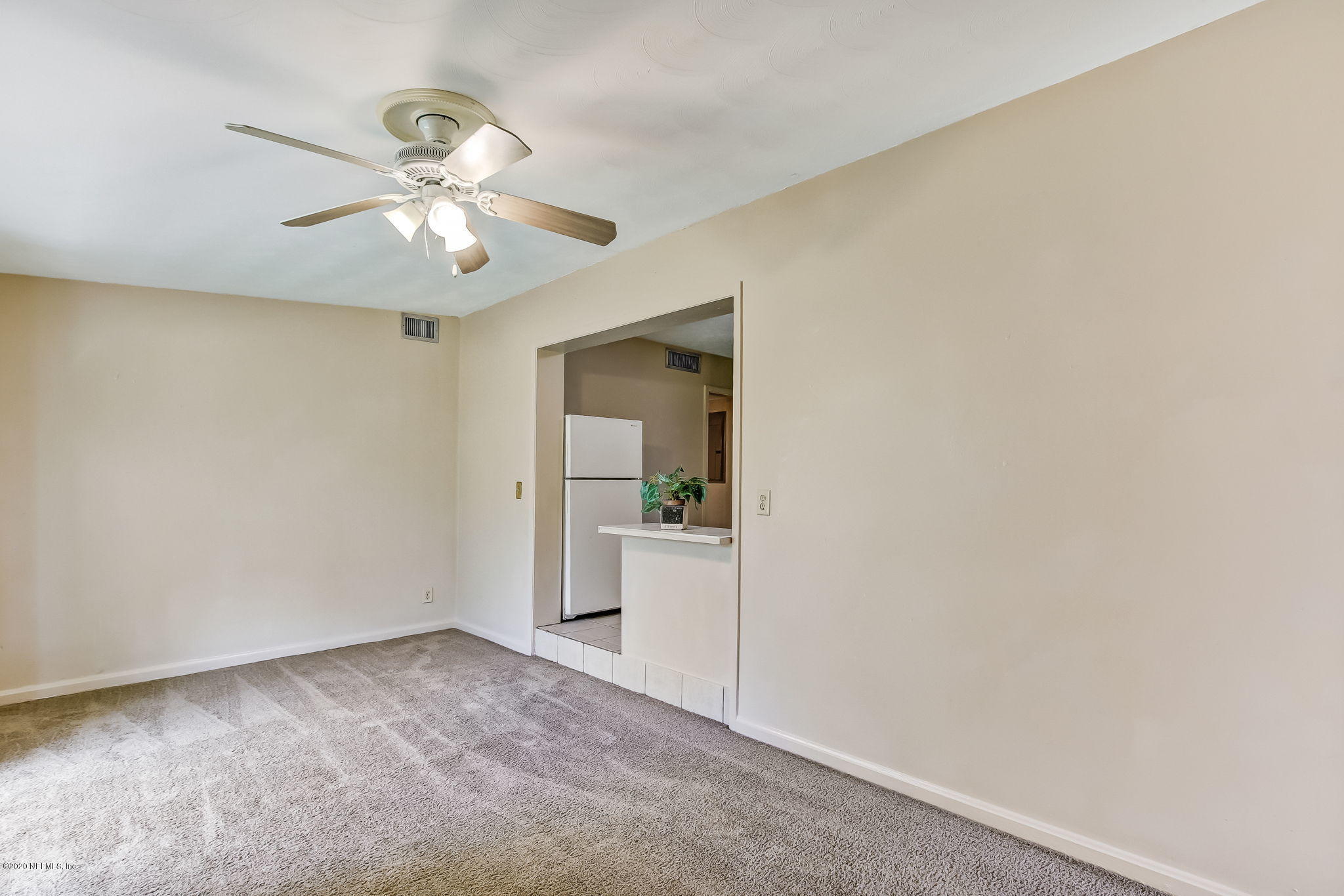 6815 King Arthur Road Jacksonville, FL 32211 - Photo 17 of 32 a view of a kitchen with a sink and a chandelier fan