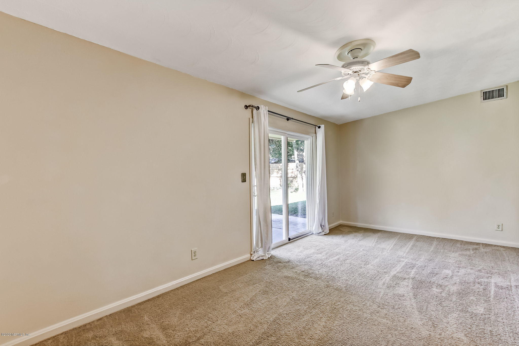 6815 King Arthur Road Jacksonville, FL 32211 - Photo 18 of 32 an empty room with windows and fan