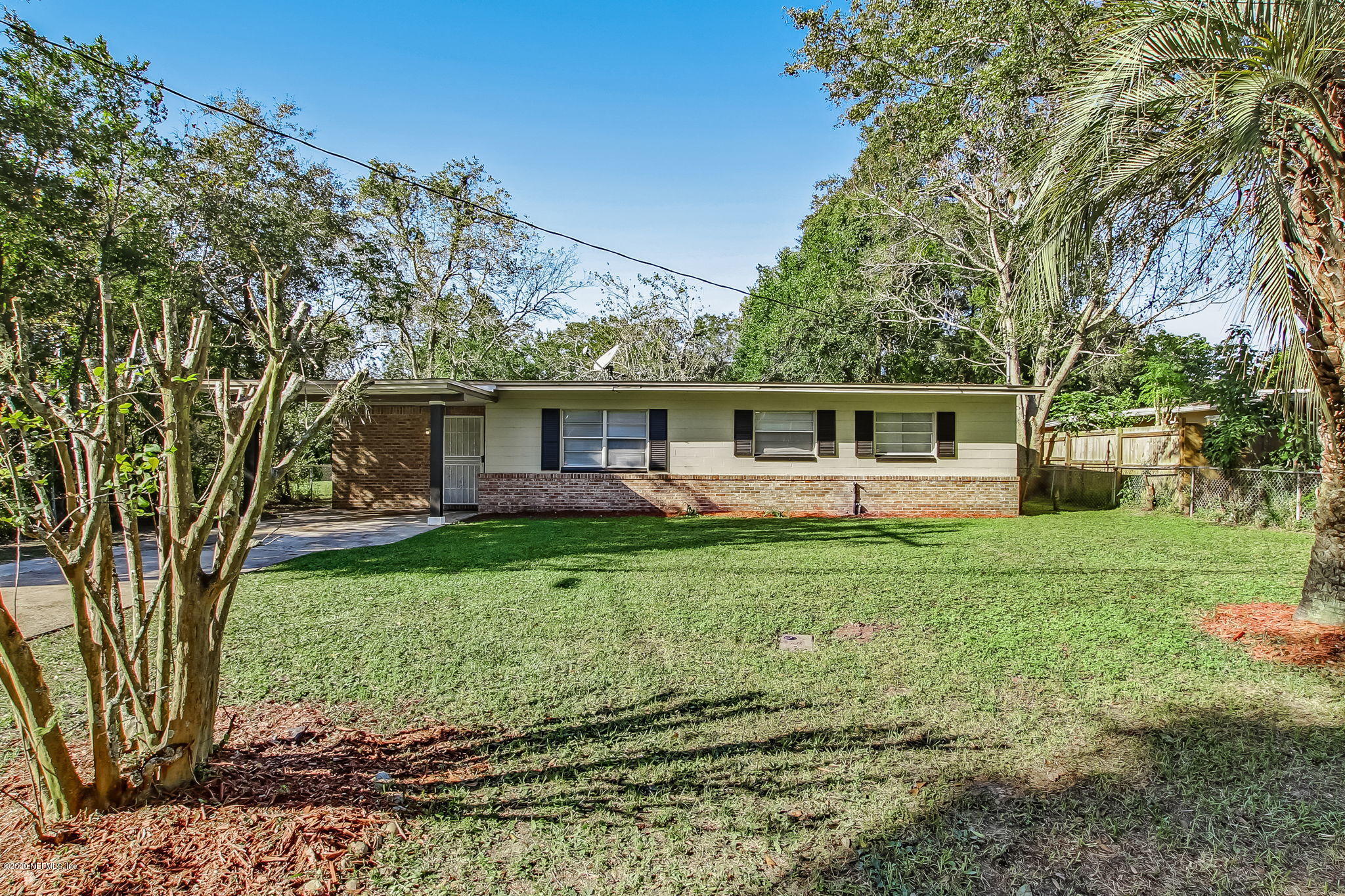 6815 King Arthur Road Jacksonville, FL 32211 - Photo 2 of 32 a view of a house with backyard sitting area and garden