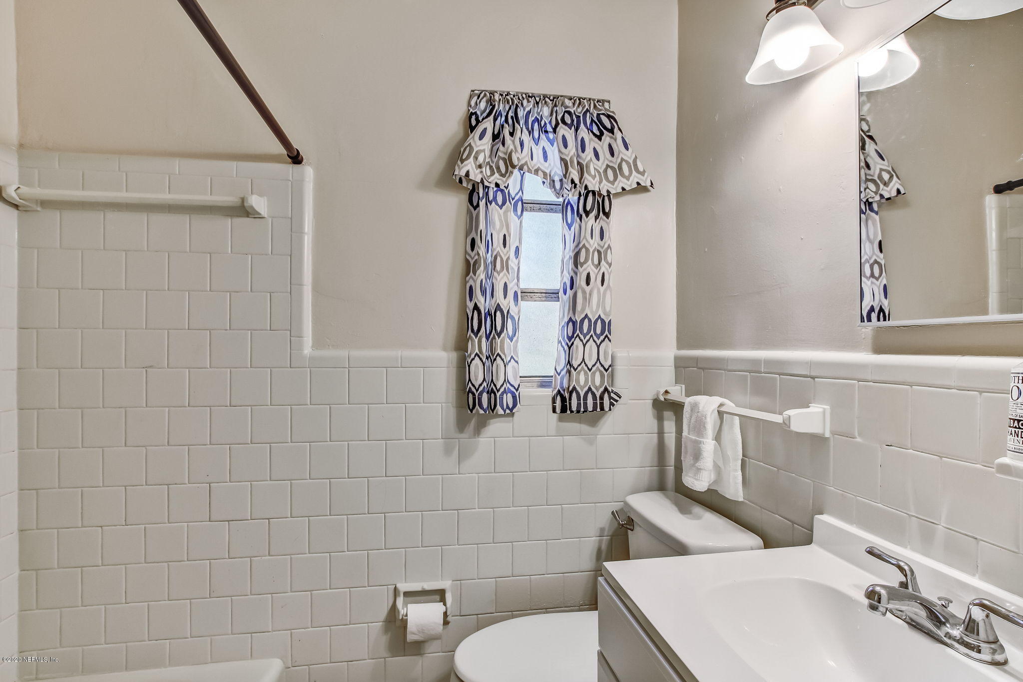 6815 King Arthur Road Jacksonville, FL 32211 - Photo 22 of 32 a bathroom with a sink a toilet and shower