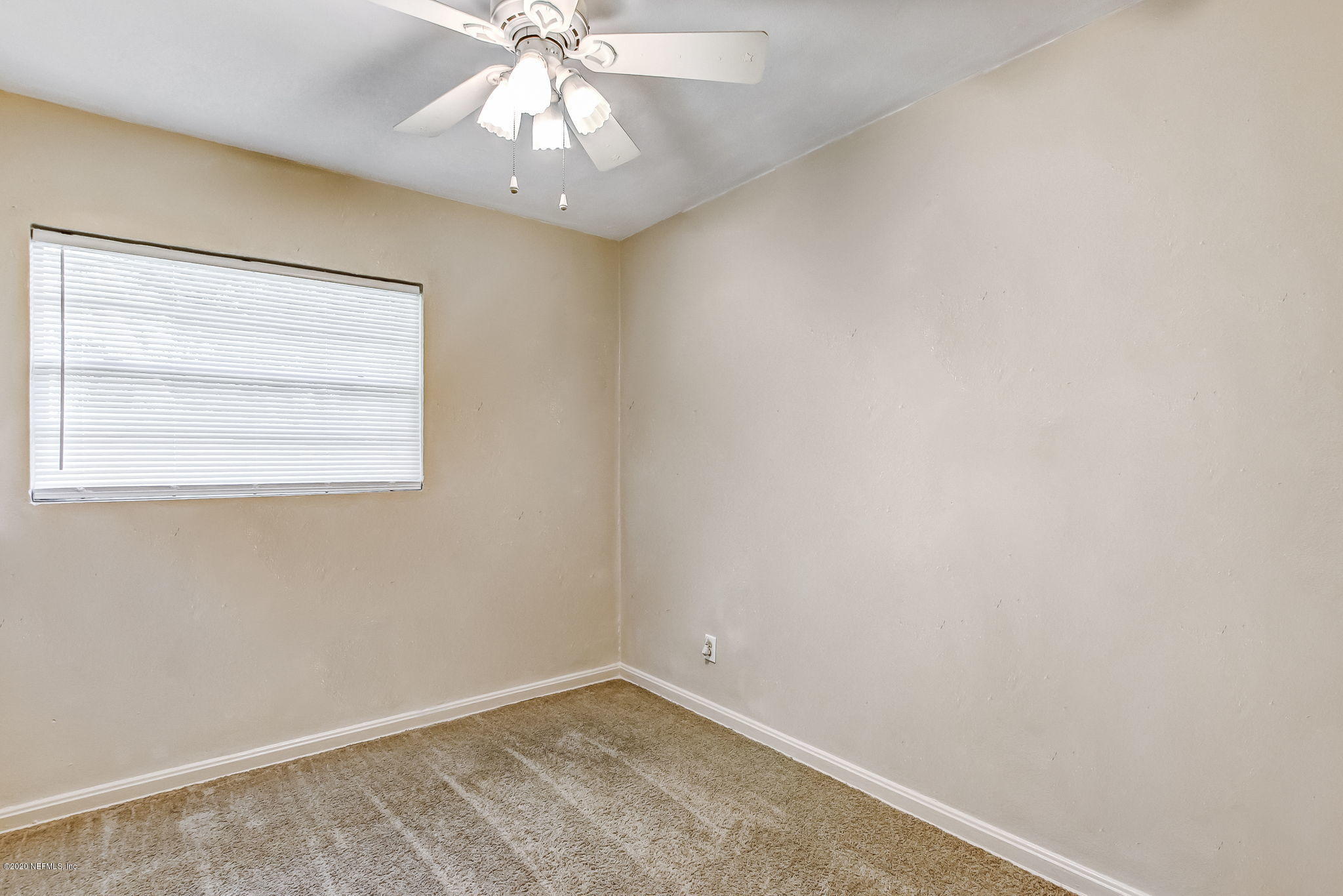 6815 King Arthur Road Jacksonville, FL 32211 - Photo 23 of 32 an empty room with a window