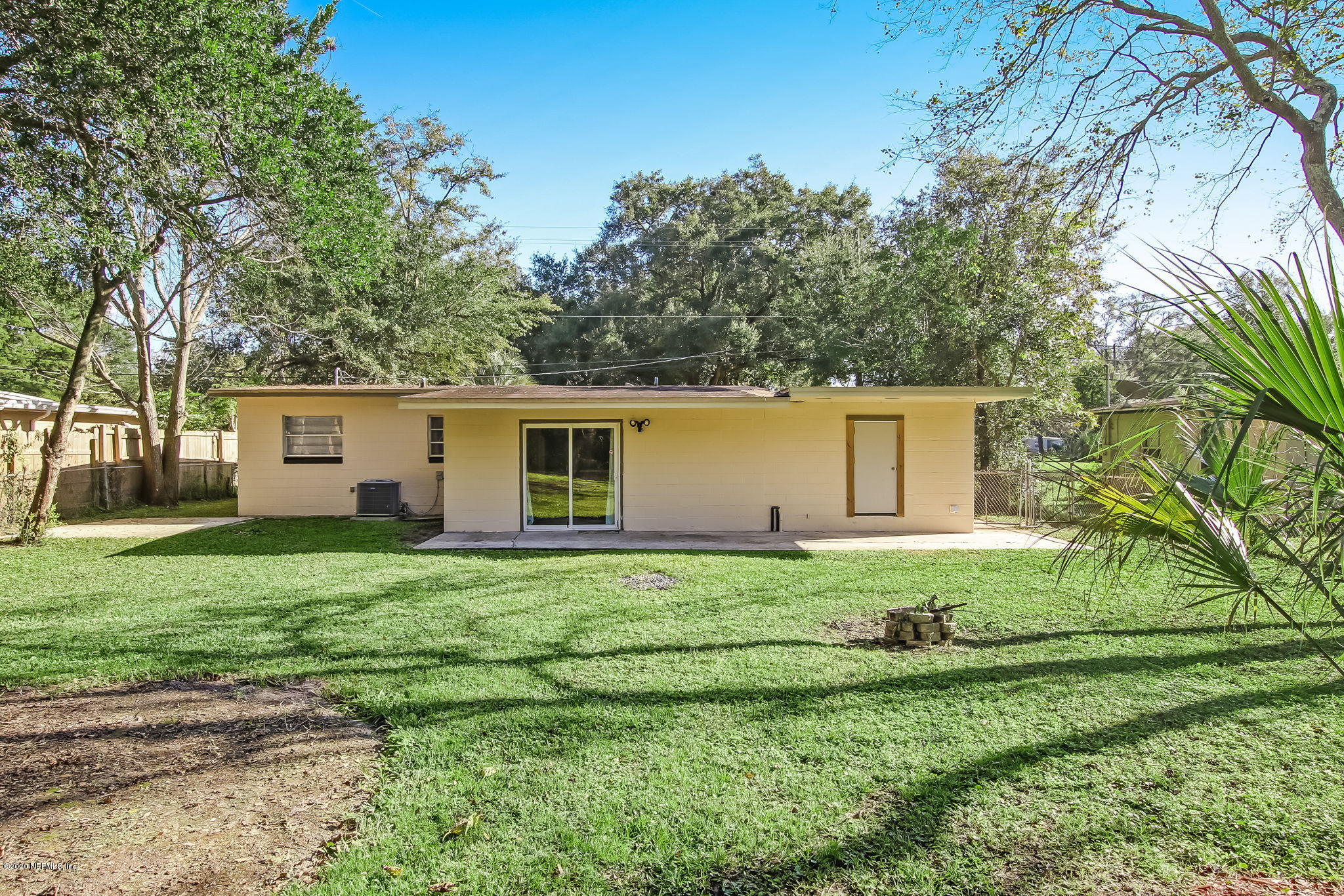 6815 King Arthur Road Jacksonville, FL 32211 - Photo 29 of 32 a backyard of a house with table and chairs