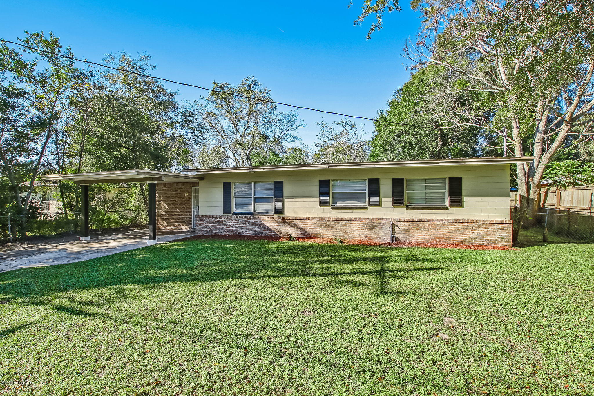 6815 King Arthur Road Jacksonville, FL 32211 - Photo 3 of 32 a front view of a house with a yard