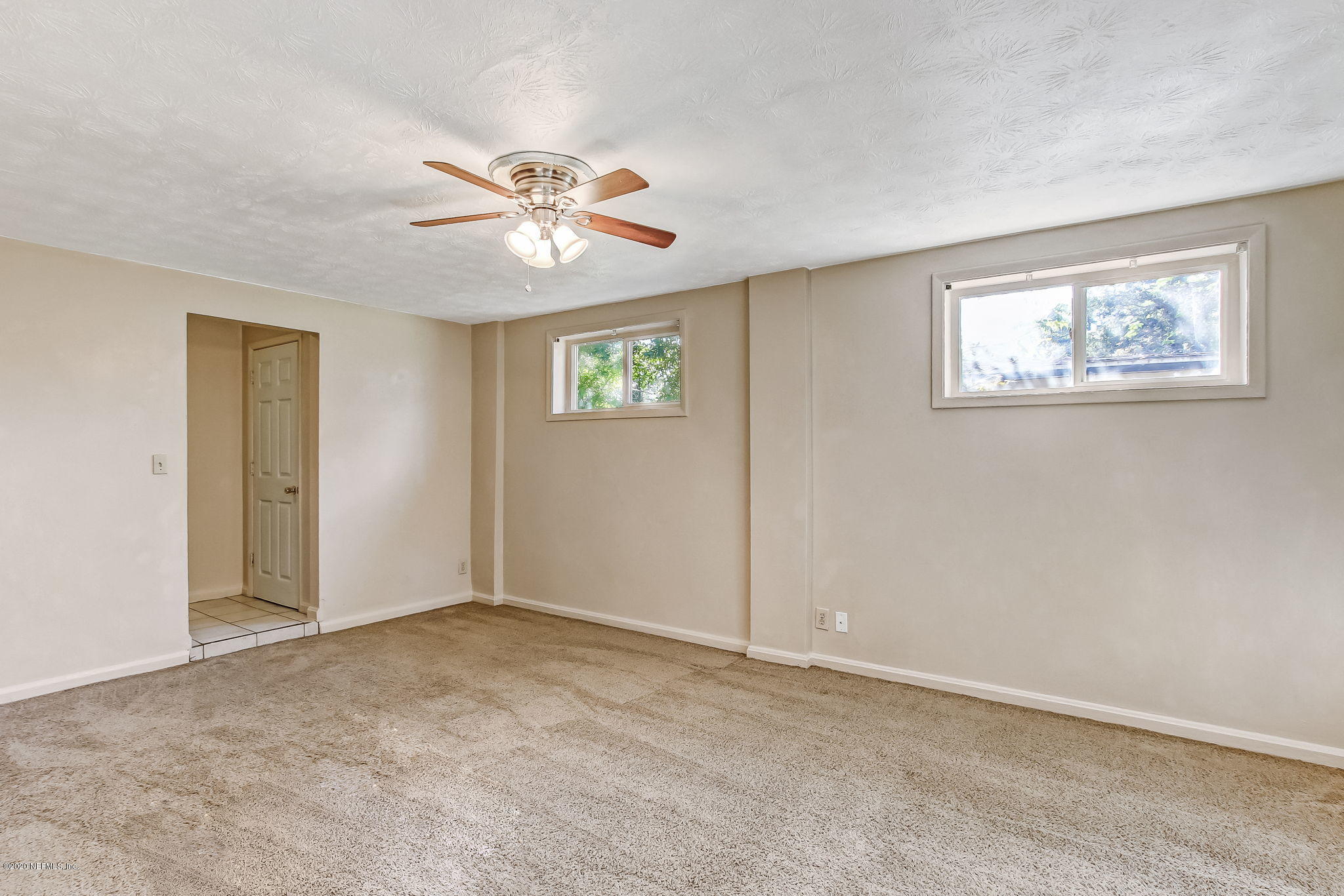 6815 King Arthur Road Jacksonville, FL 32211 - Photo 9 of 32 a view of an empty room with a window