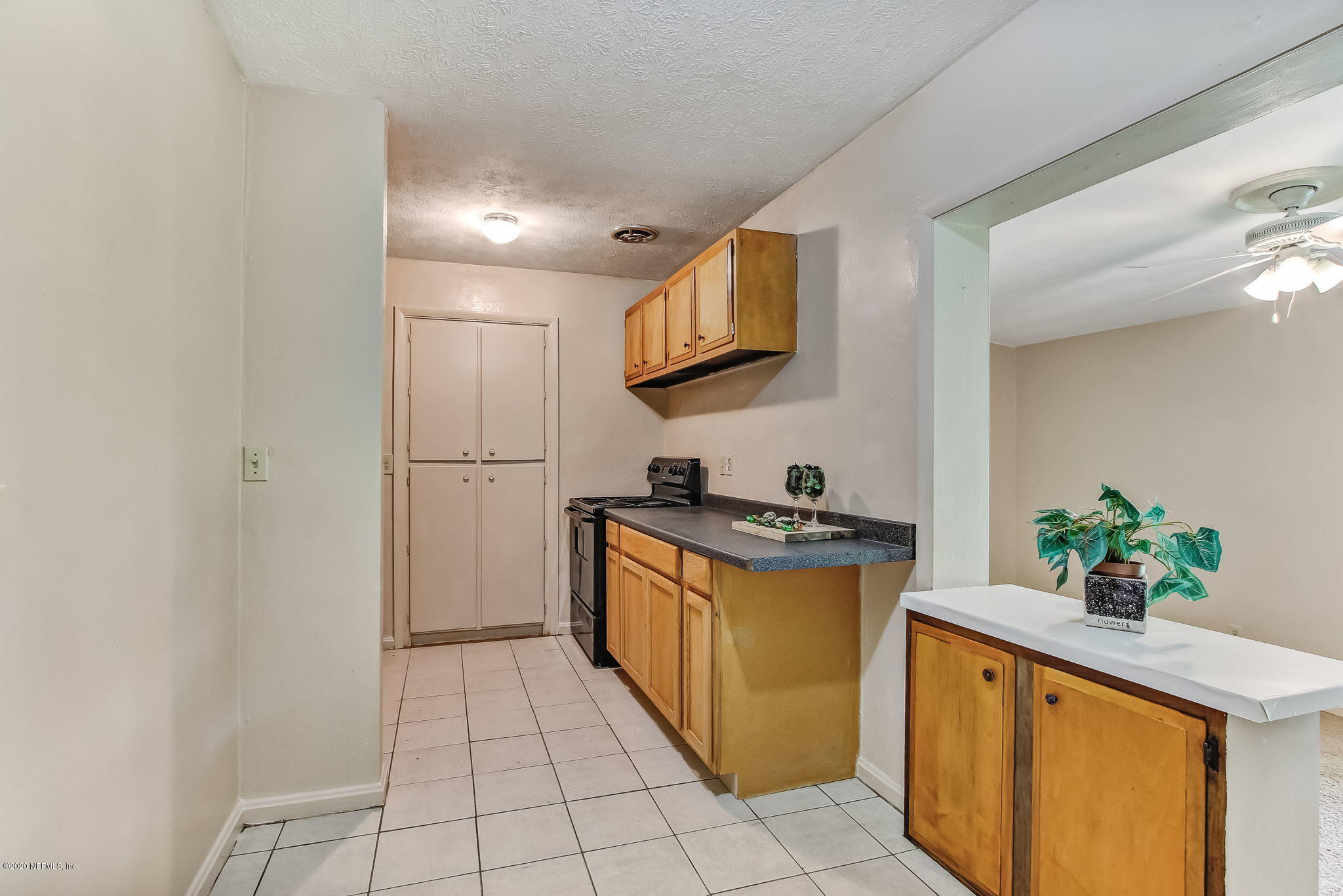 6815 King Arthur Road Jacksonville, FL 32211 - Photo 10 of 32 a kitchen with stainless steel appliances granite countertop a refrigerator a stove top oven and a sink