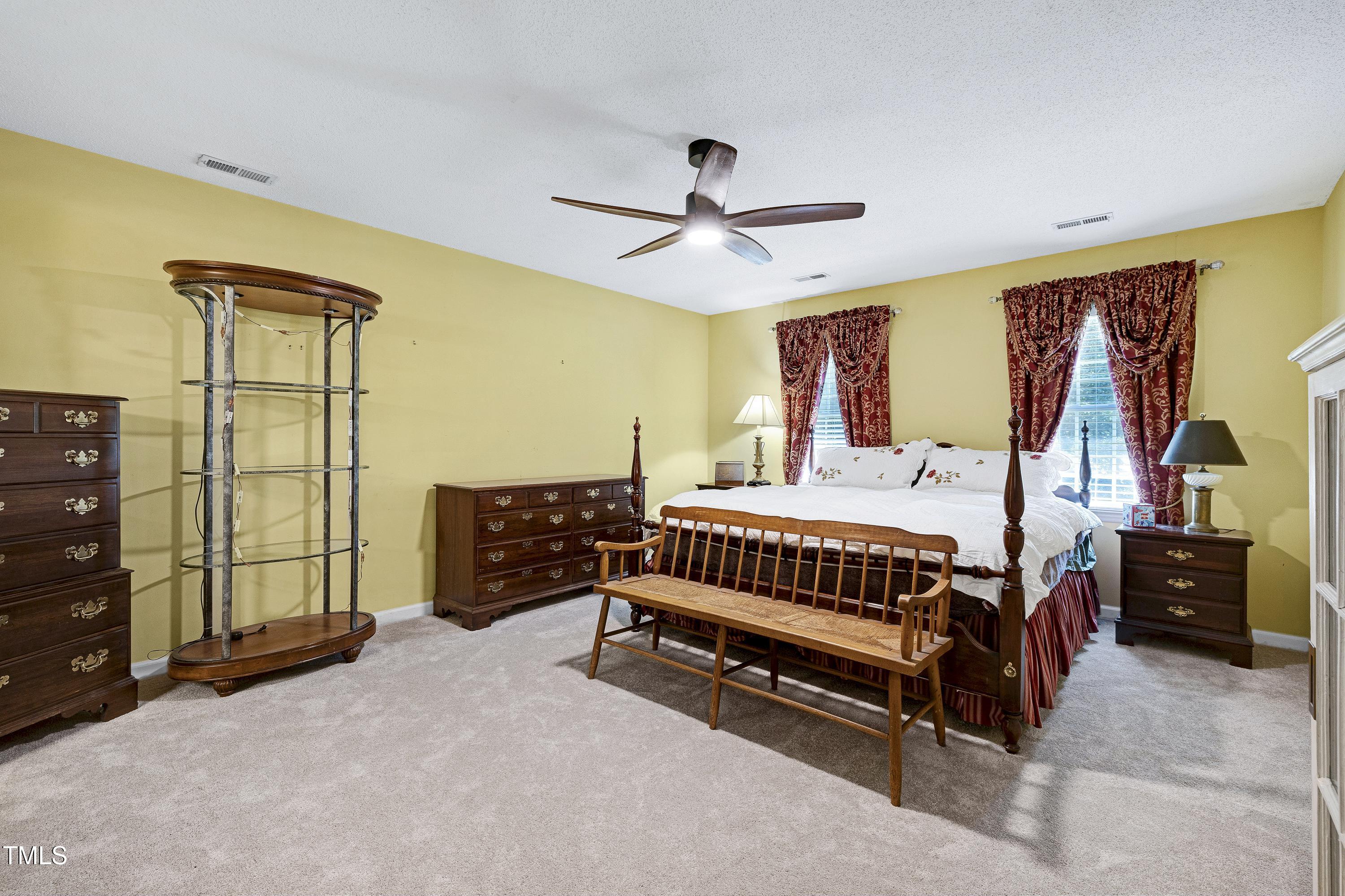 6309 Windy Ridge Court Raleigh, NC 27606 - Photo 18 of 53 a bedroom with a bed and a chandelier