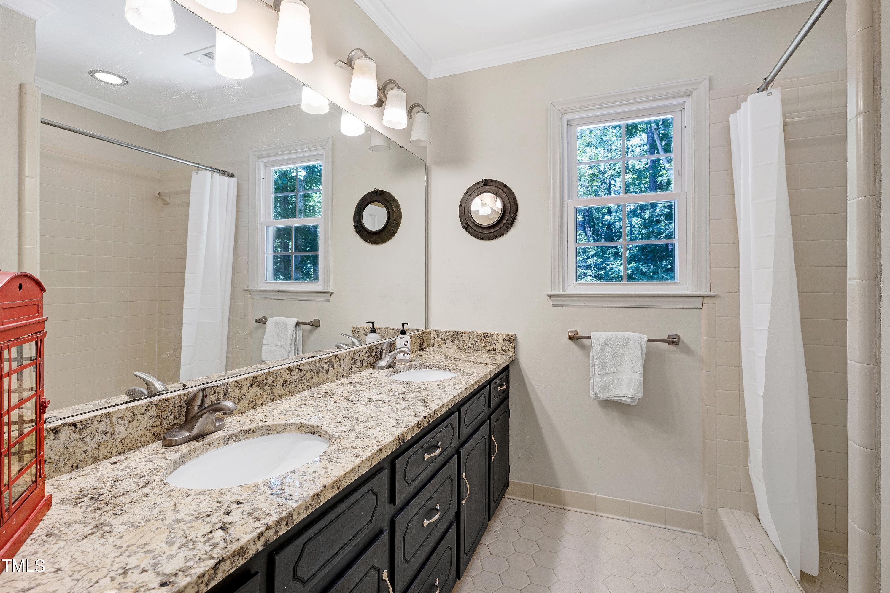 6309 Windy Ridge Court Raleigh, NC 27606 - Photo 20 of 53 a bathroom with a granite countertop sink and a mirror
