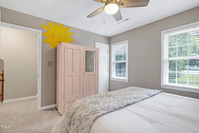 a spacious bedroom with a bed and a chandelier