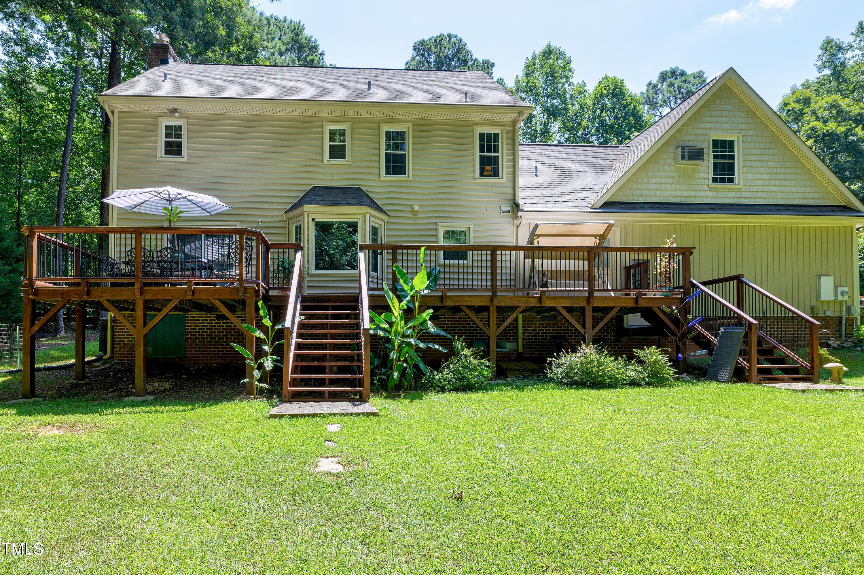 6309 Windy Ridge Court Raleigh, NC 27606 - Photo 41 of 53 a front view of a house with garden