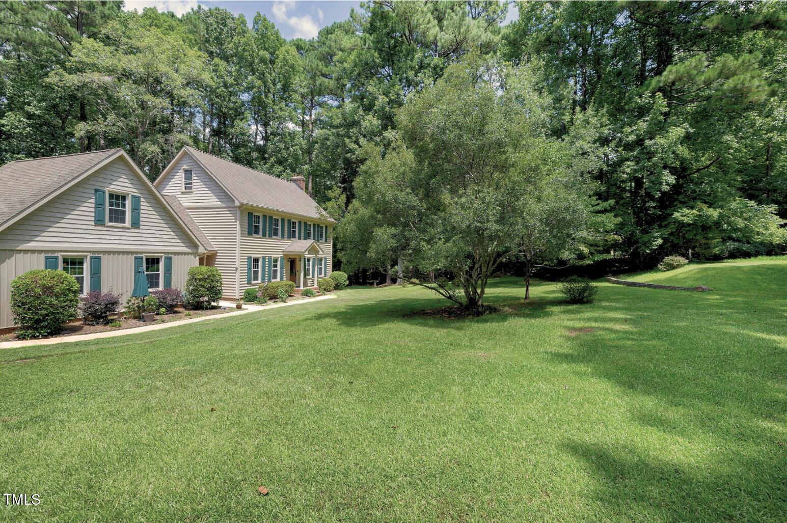 6309 Windy Ridge Court Raleigh, NC 27606 - Photo 46 of 53 a front view of a house with a garden