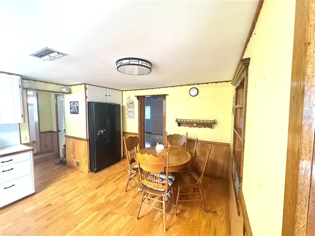 a view of a dining room with furniture and a kitchen