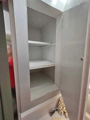 a dining room with furniture and a floor to ceiling window