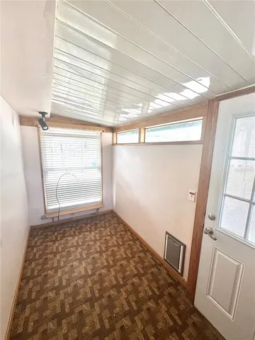 a view of a glass door with a yard from a balcony