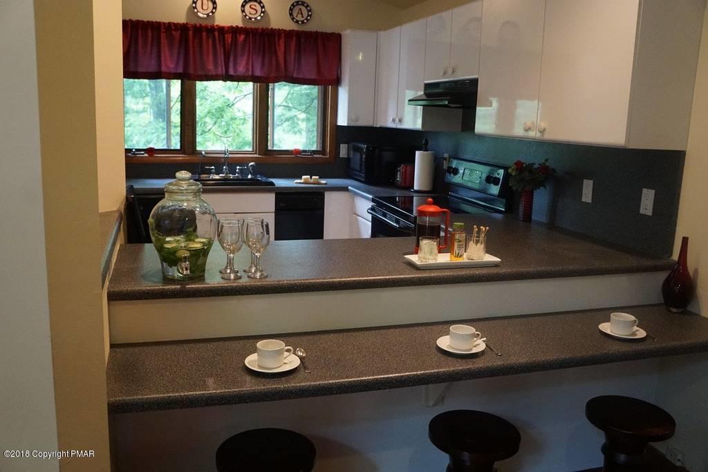 179 Radcliff Road Bushkill, PA 18324 - Photo 16 of 32 a kitchen with a stove and a microwave