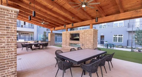 a view of a patio with table and chairs and potted plants