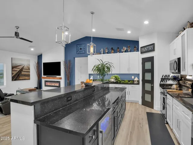 a kitchen with stainless steel appliances a stove sink microwave and cabinets