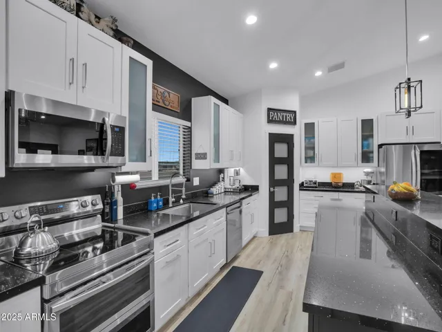 a bathroom with a sink toilet vanity and shower