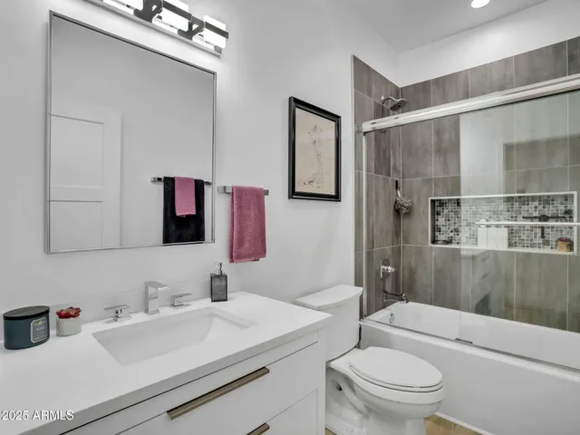 a bedroom with a bed and a desk