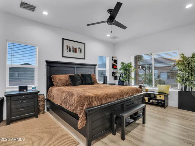 a bathroom with a toilet sink double vanity and mirror