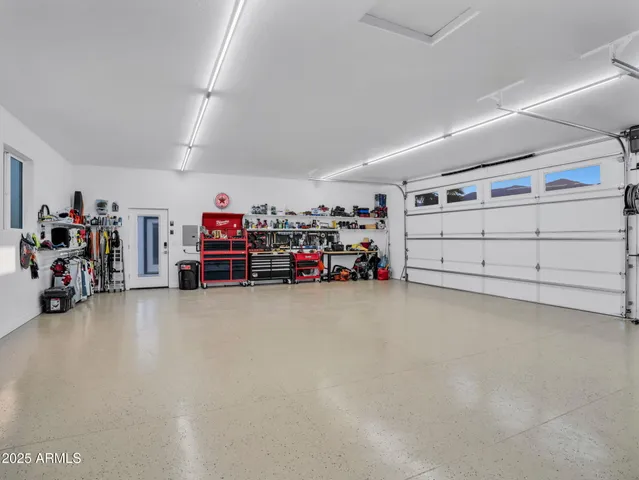 a room with stainless steel appliances kitchen island granite countertop a table and chairs in it