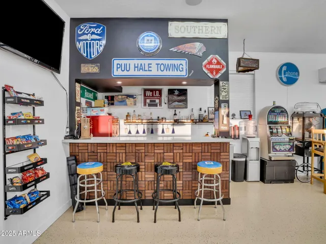 a view of chairs and tables in the back yard of a house